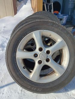 Four Nissan 5 Lug Tires and Rims