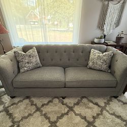 Ashley Furniture gray sofa and loveseat.