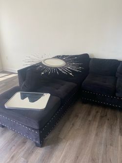 Black, velvet couch and ottoman