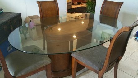 Glass dining table with four chairs