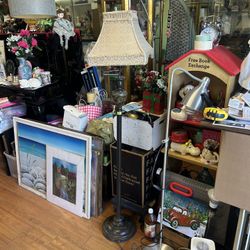 Vintage heavy-duty cast iron floor lamp with a dark bronze and antique gold finish, featuring a glass mid-section and a patterned fabric shade