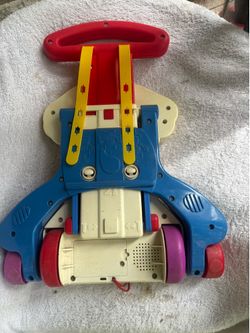 This toy is a vintage 1999 Fisher-Price "Bingo" Dog Activity Walker / Crib Toy.