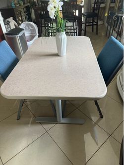 Meta leg table 48” long 30” wide and 29” high and 2 metal chairs in good condition