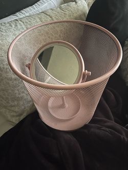 pink trash can and mirror