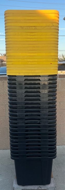 23 black storage totes and 23 yellow lids  27 gallons