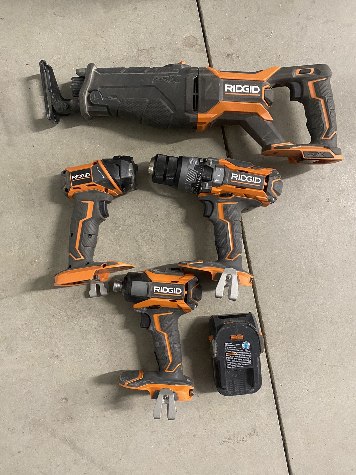 Assorted power Drills, Flashlight, and Battery Pack Rigid Brand 