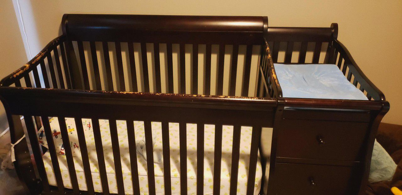 Baby Crib with attached changing table and drawers and shelves