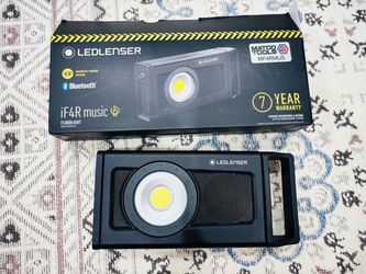 LED floodlight featuring a built-in Bluetooth speaker and magnetic charging system