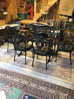 Wrought iron table and chairs .