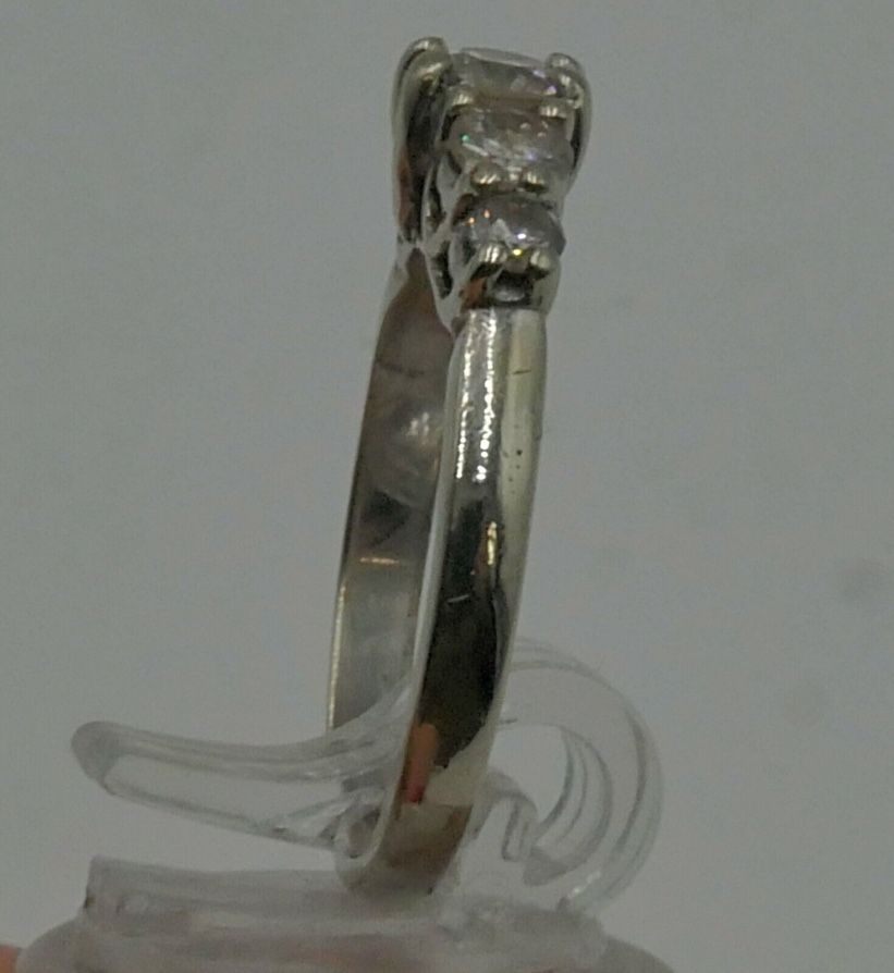 14KT WHITE GOLD ANNIVERSARY BAND SIZE 7.5 3.8 GRAMS WITH 5 DIAMONDS APPROXIMATE CENTER ROUND DIAMOND 0.30 0.35PTS SI2 H; 2 SIDE DIAMONDS 0.16 0.18