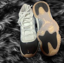 brown and white Jordan 11 Retro trainers