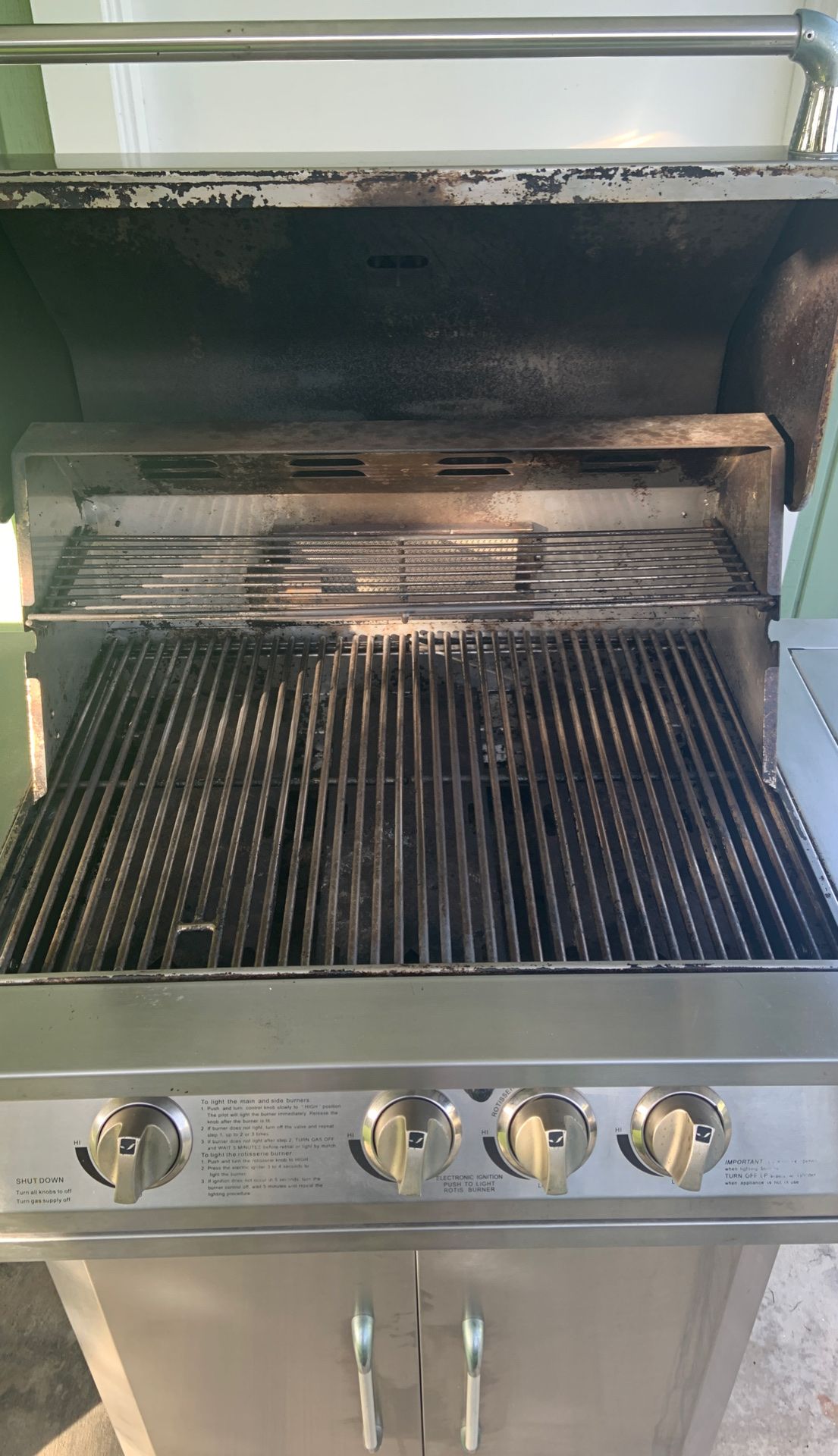 Stainless steal JennAir BBQ with stainless grills and a canvas cover