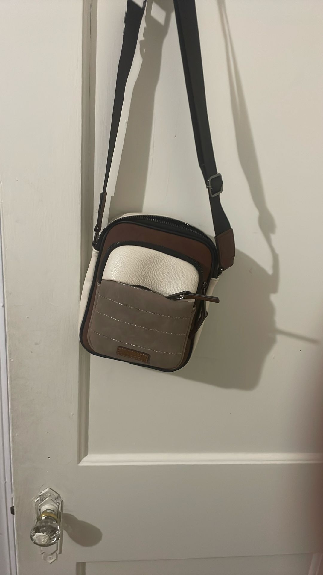 The bag in the image is an Aldo Krill260 Beige & Brown Color Block Medium Cross Body Bag