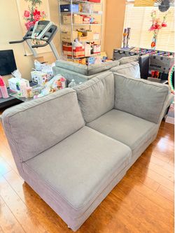 Grey Modular Sectional Sofa with Ottoman and Glass Coffee Table