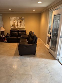 Two matching brown leather couches, larger with power recline.
