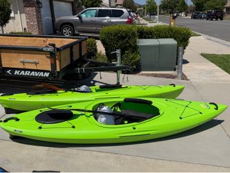 2 lifetime kayaks with paddles and covers