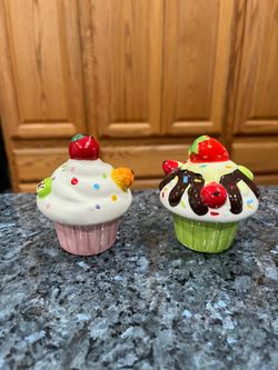 Ceramic Cupcake Pair of Salt and Pepper Shakers.  Perfect for decorating a Birthday Party Celebration.  Size approximately 3 inches tall.  Preowned ne