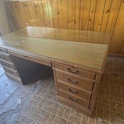 Traditional wood double pedestal executive desk with a glass top