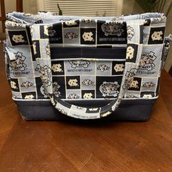 Brand New UNC Purse.  Has Plenty Of Room With A Snap To Close.  Measures  9 By 14.  $25 Or Best Offer. 