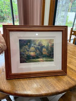 Thomas Kincaid print in a wooden frame