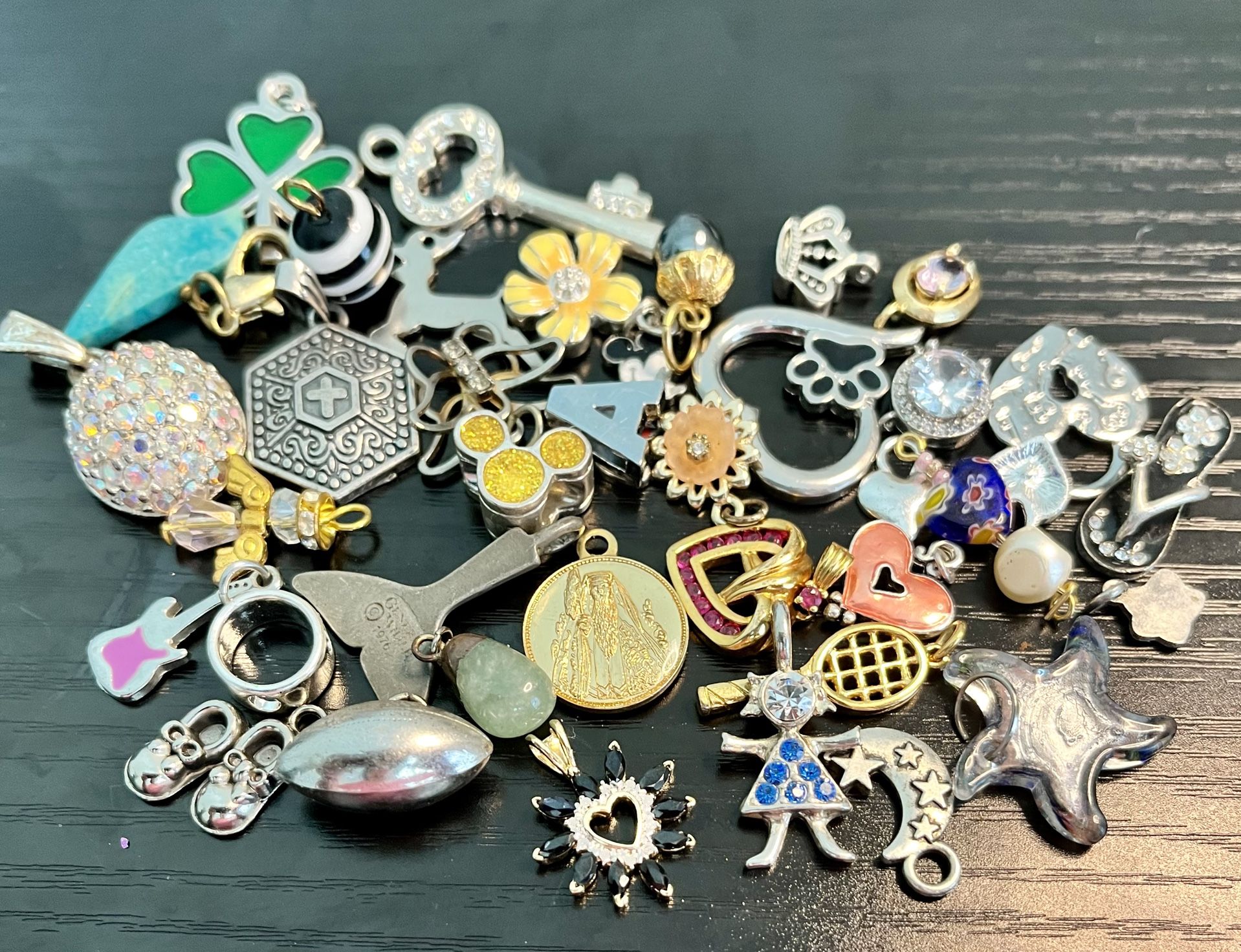 Vintage Pendants and trinkets. These pendants and trinkets are small. As is. No returns. What you see is what you get. Make me an offer I can’t refus
