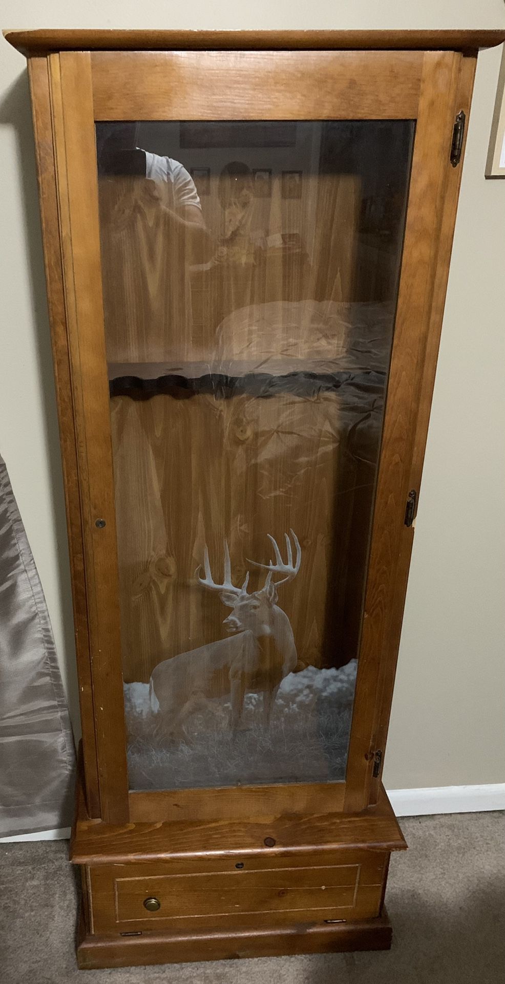 Gun cabinet (holds 6 plus guns), wooden with deer frosted decorative glass display with lock and storage below with lock. Bottom storage wooden door i