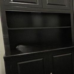 Black wood Thomasville book shelf with two cabinets and light. 
