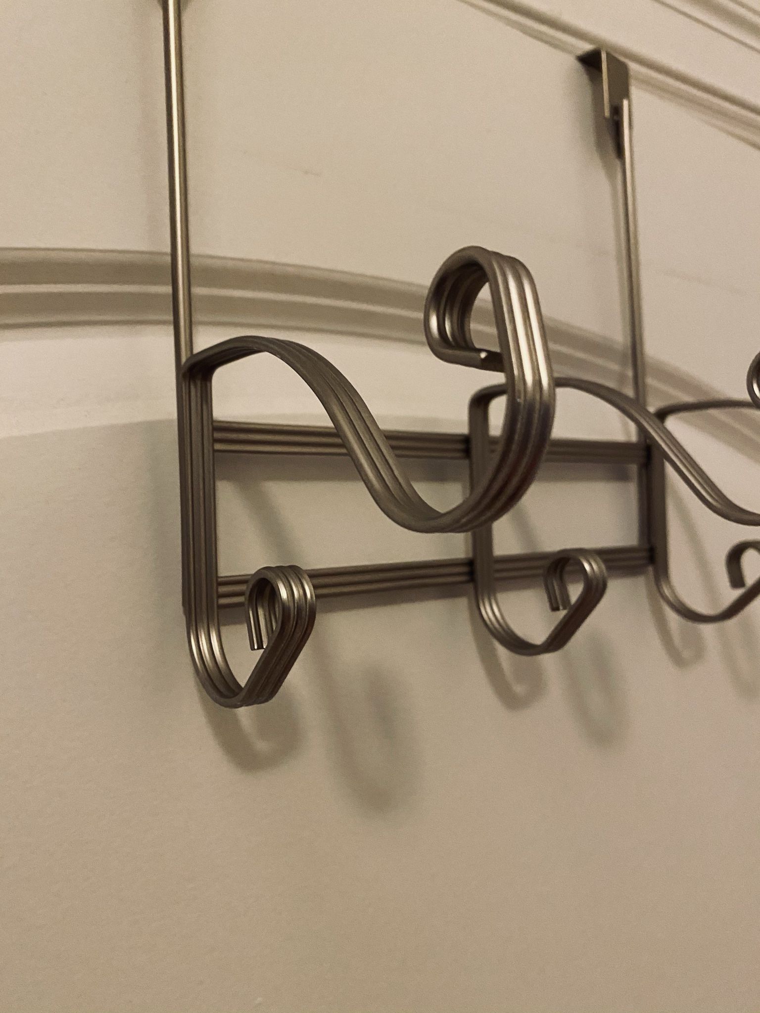 Hanging Over-Door: 3 Double-Hooks Hanger. Nice design. New. Never used. Great bargain. 8.5” wide.