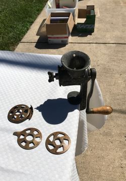 Antique meat grinder with blades and wood handle