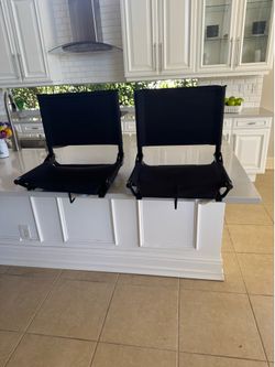 Two stadium chairs for comfort on bench