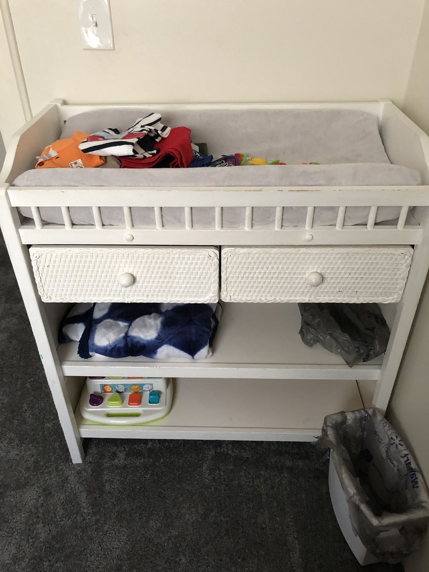 Baby wicker/wood changing table with 2 drawers and additional storage.