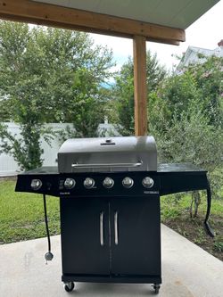 Charbroil Propane Grill with side burner. Includes full propane cylinder.