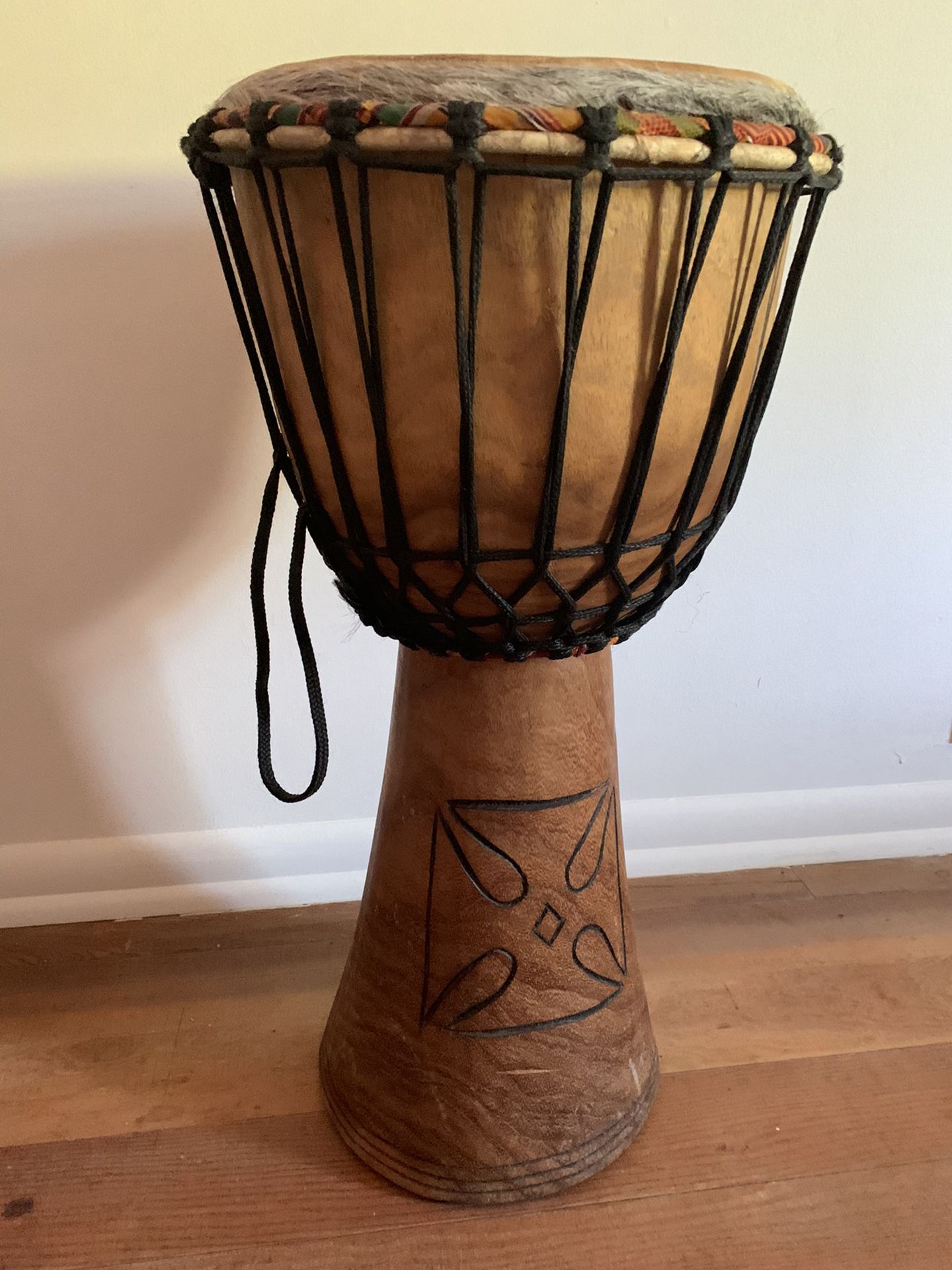 Djembe 12” drum with custom storage bag.