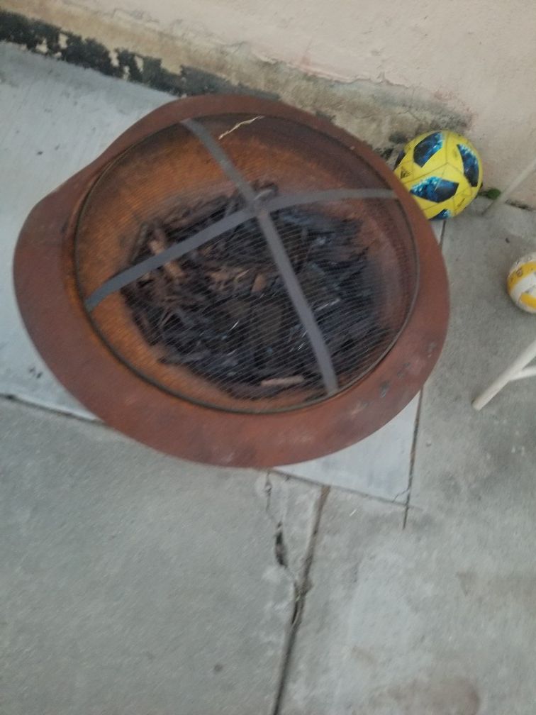 Fire pit with firewood bundle