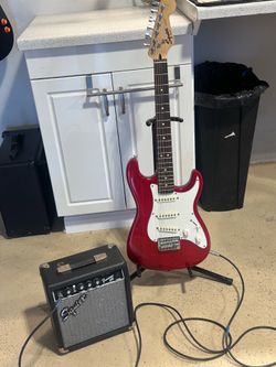 Fender guitar, amp, chord and stand
