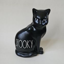 Rare Rae Dunn Halloween Black white Spooky kitty Cat Ceramic figurine Decoration Measures 7.5"L x 5.5"W x 7.5"H Add a touch of spookiness to your Hall