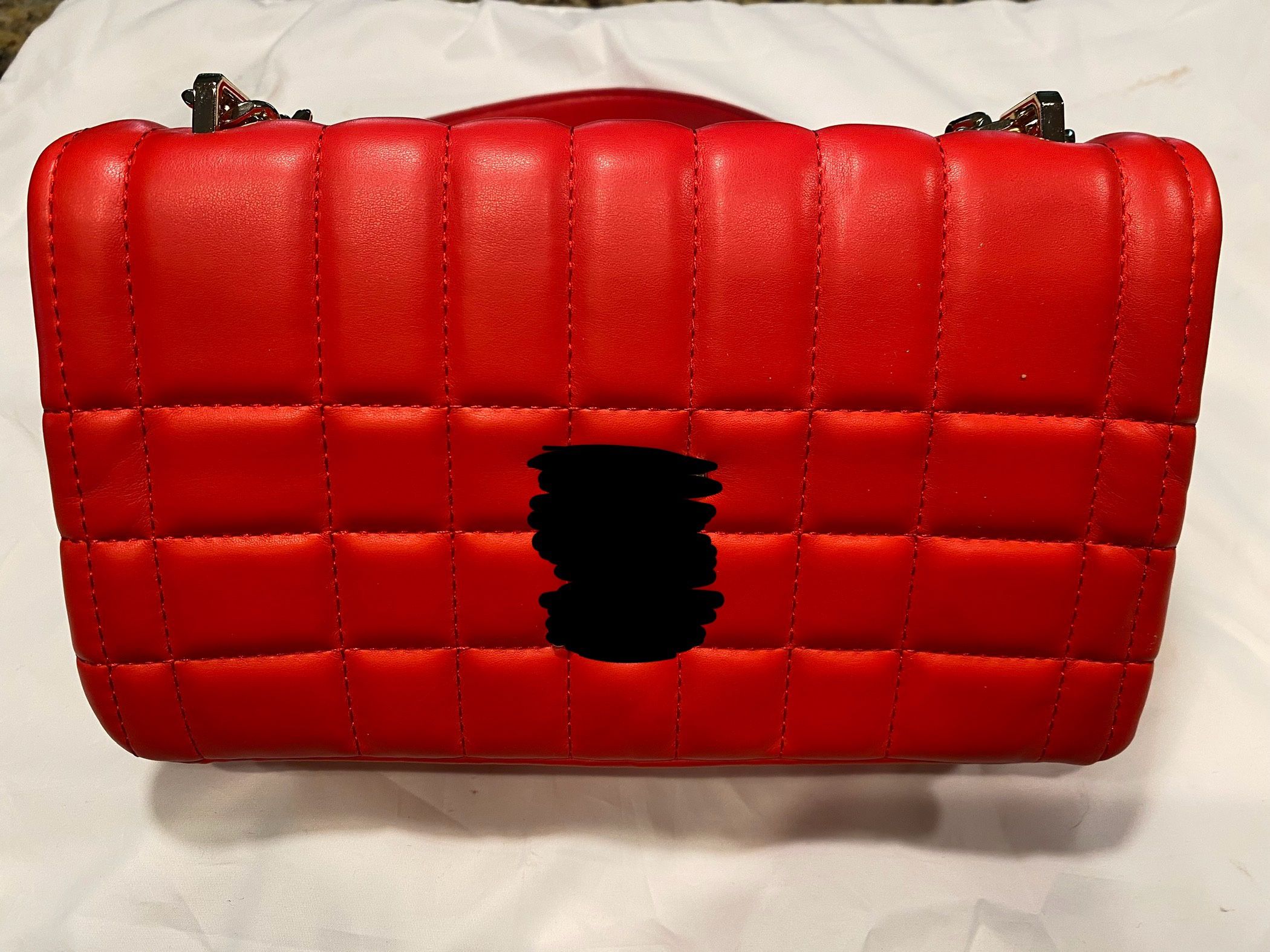 Quilted shoulder purse and gold hardware.