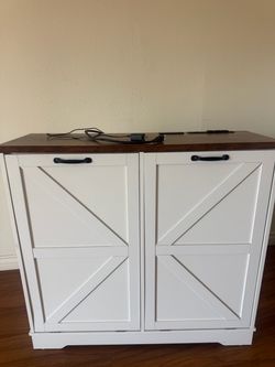 Tilt out trash can cabinet