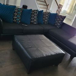 Black Sectional, Ottoman And 2 Pieces Of wall Art