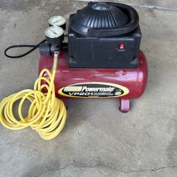 Coleman Powermate VP201 air compressor w/ yellow coiled hose