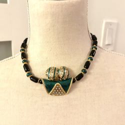 Vintage necklace and earring set (possibly from the 80s) that combines black and green beads with a distinctive green enamel center pendant and rhines