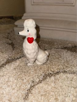 White poodle figurine with red heart