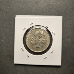 The product is a circulated 1976 Greek 10 Drachmas coin made of copper-nickel. This vintage coin from Greece features a denomination of 10 Drachmas 