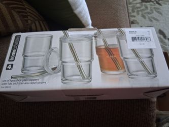 Mini shot glass sippers with lids and stainless steel straws.