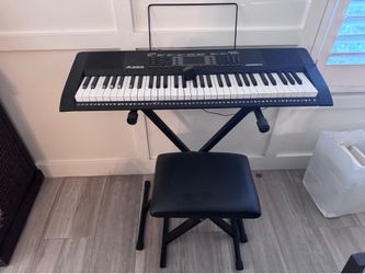 Piano on stand with music stand and stool