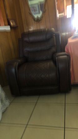 Brand new recliner with buttons on side to pick up feet