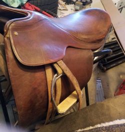 English leather saddle and stirrups approximately 20 inch seat made in Argentina