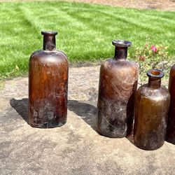 Nine brown Antique Apothecary Bottles 