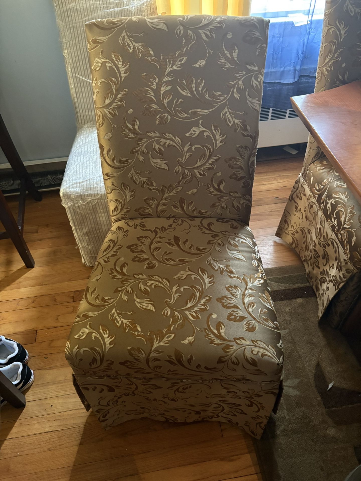 four golden covered chairs