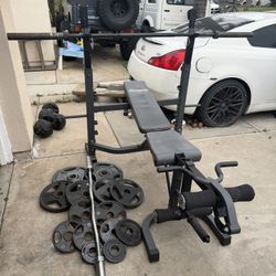 Bench press with 7ft 35lbs bar and 215lbs of Olympic weights and curl bar